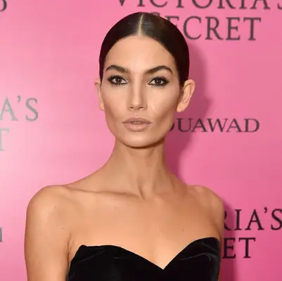 Lily Aldridge wears a sleek low bun with center part