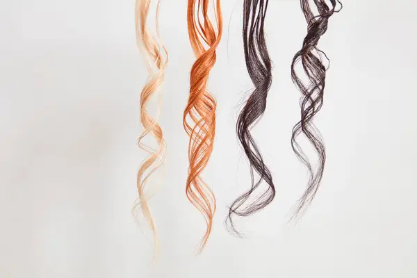 Hands curling dark brown hair with the ghd Classic Curl 1-Inch Curling Iron