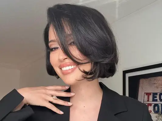 Close up of actor Christian Serratos with a shiny, bouncy bob