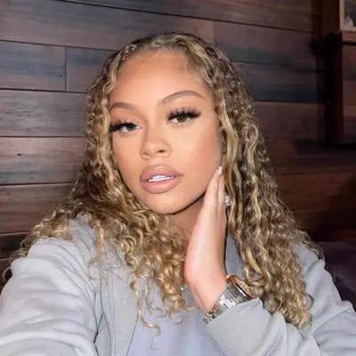 Latto taking selfie that shows of her Honey Blonde hair