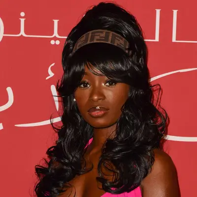 DJ Young Wavy Fox with a curly bouffant and curtain bangs