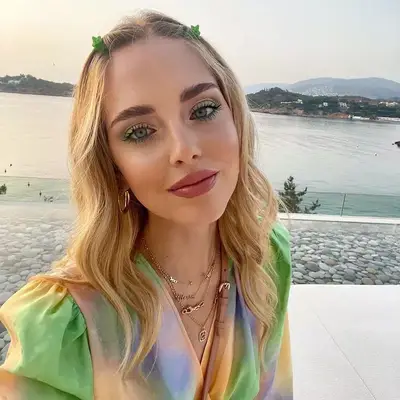 Chiara Ferragni wears her blonde hair down and curled with two green butterfly clips