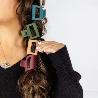 Long wavy hair with blue, green, yellow, and orange rectangular claw clips