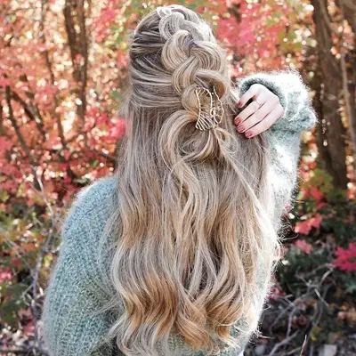Back view of long, blonde hair with half-braided style with gold wire claw clip