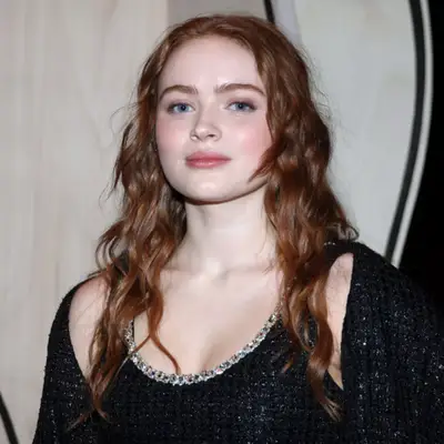 Emma Roberts with bright copper hair color and red lipstick