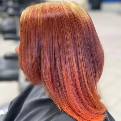 Blonde to red reverse ombré hair