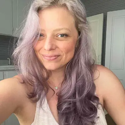 Woman with blonde to lavender reverse ombré hair
