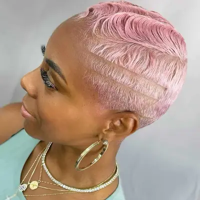 Woman with short buzzed hair with white to pink reverse ombré hair