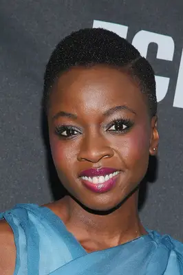 Danai Gurira with a close crop with hard part on natural hair