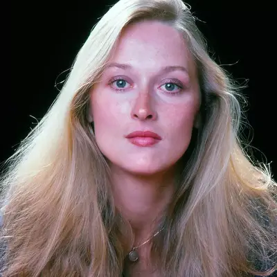 Meryl Streep wears long, blonde hair with a side part in 1976