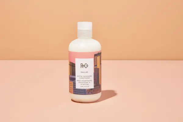 R+Co Dallas Biotin Thickening Conditioner on table