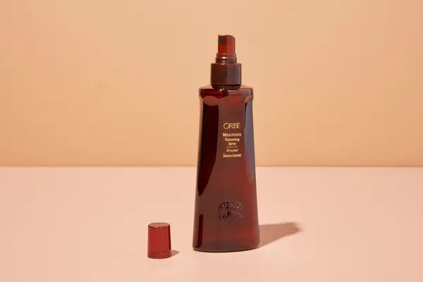 Oribe Maximista Thickening Spray on table