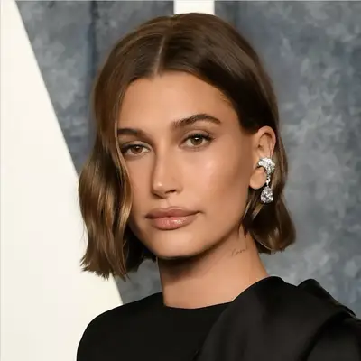 Hailey Bieber with chocolate brown hair and blonde babylights