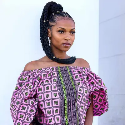 Goddess braids tied in a high ponytail with hair charms 