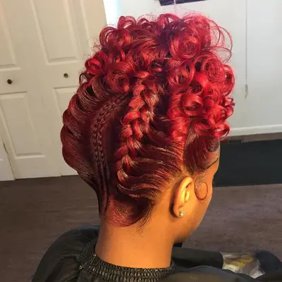 Bright red goddess braids tied into a curly high hairdo