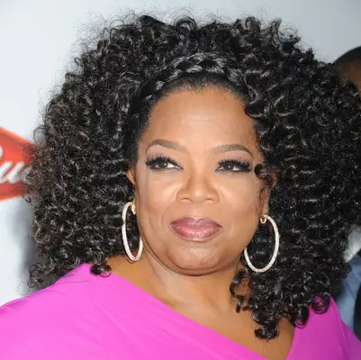 Oprah Winfrey in goddess braids with a braided headband at 