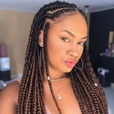 Goddess braids worn in a symmetrical middle part