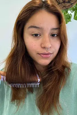 A person uses the Tangle Teezer The Ultimate Detangler