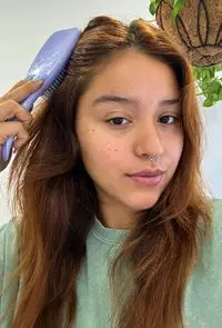 A person uses the Tangle Teezer The Ultimate Detangler