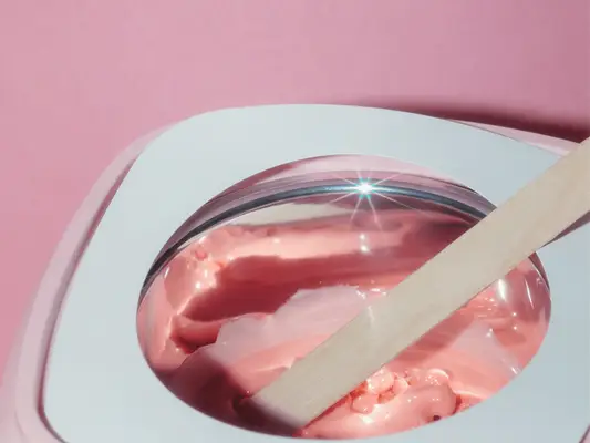 pink hair wax warmer on pink background