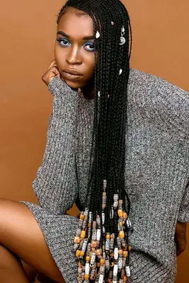 Black woman wearing long hair in beaded braids
