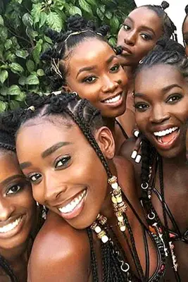 five Black women in braids with beads