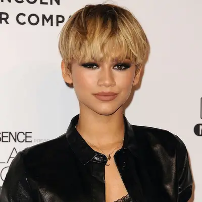 Zendaya with a honey blonde pixie and smoky eye 