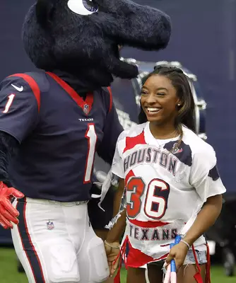 Simone Biles wearing a half-braided updo.