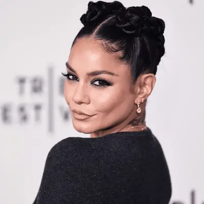 Vanessa Hudgens with rope braided buns and center part, zoomed in