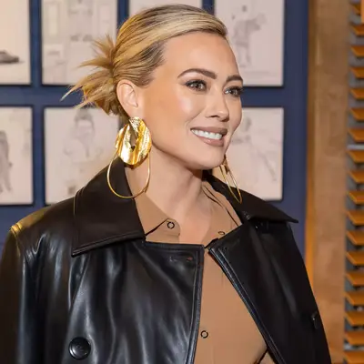 Hilary Duff wears a low side-parted spiky bun to the premiere of 