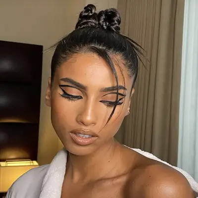 Imaan wearing a bun made of twists with some lightly feathered spikes