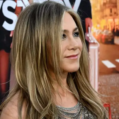 Jennifer Aniston with blonde highlights and layered haircut