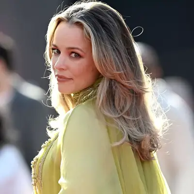 Close up of Rachel McAdams posing with layered blonde blowout and a green shirt