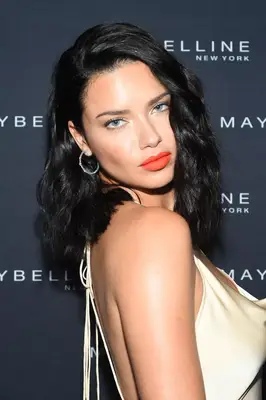 Adriana Lima thick, wavy mid-length hair