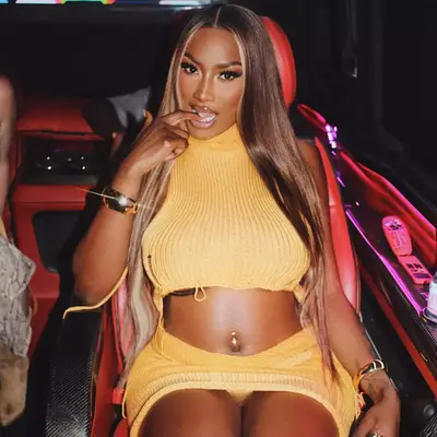 Aya Nakamura with long straight middle part bronde hair