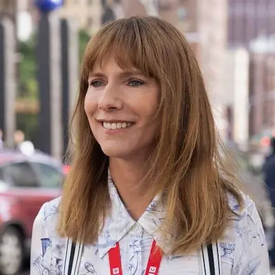 Dolly Wells smiling outdoors