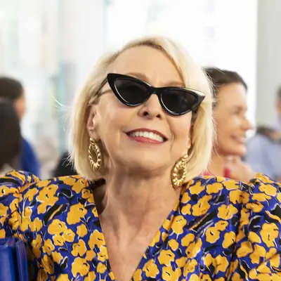 Julie Halston in stylish sunglasses, Maddie Corman and Kristin Davis in the background
