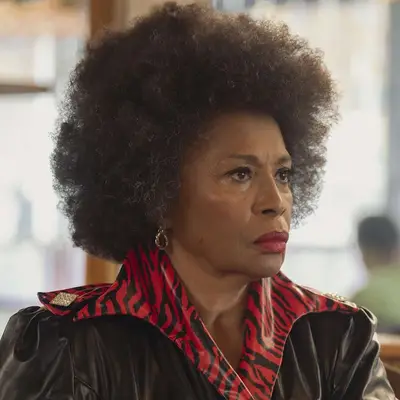 Jenifer Lewis sitting in a room, looking to the side