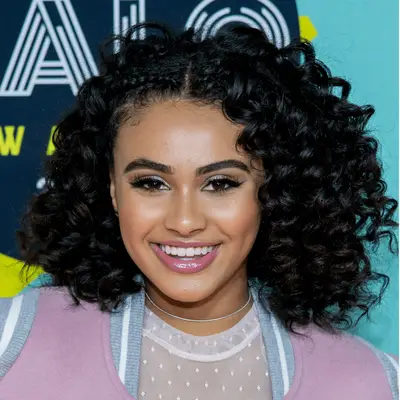 Daniella Perkins wearing curly bob with cornrows hairstyle