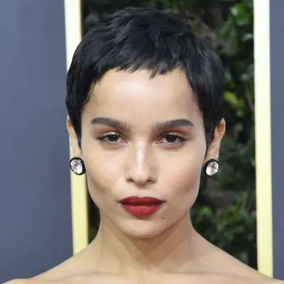 Zoe Kravitz wears a pixie cut with baby bangs and oversized stud earrings