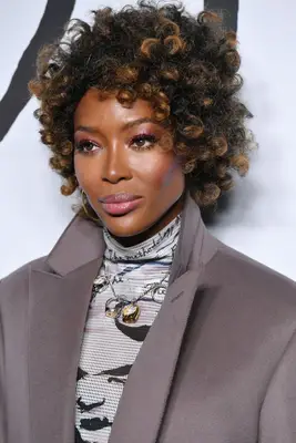 Naomi Campbell short curly natural hair with highlights