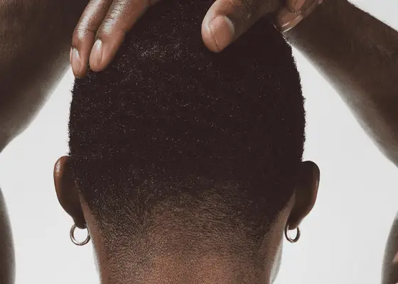 woman holding back of short hair on white background