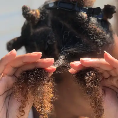 Bianca Lambert twisting her hair