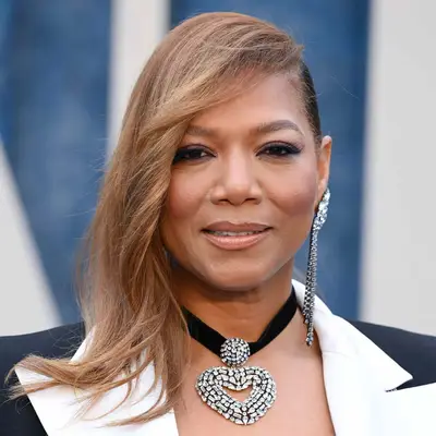 Queen Latifah wears her golden brown hair in an over-directed style