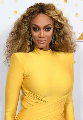 Tyra Banks in a yellow dress