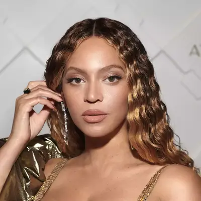 Beyonce on the red carpet, viewed close up, hand on her hair