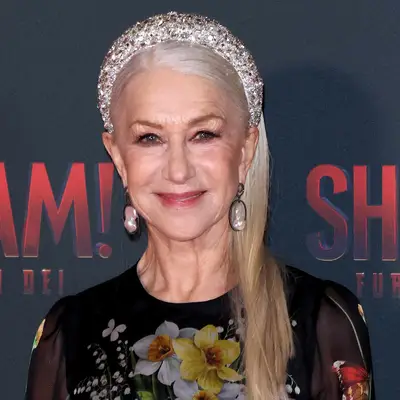 Helen Mirren with straight blonde hair and a puffy bedazzled headband at the 
