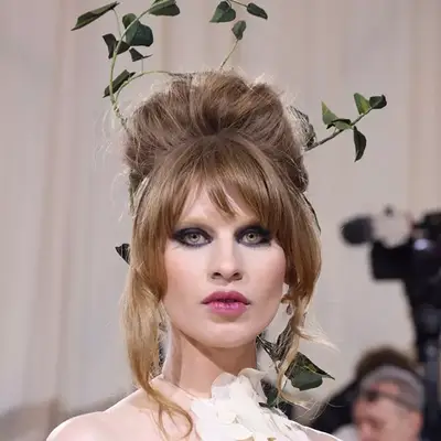 Ivy Getty wearing a bouffant with sprays of green plants at the Met Gala