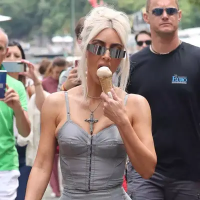 Kim Kardashian sporting a bouffant hairstyle while eating ice cream in Italy.