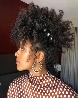 Curly fro hairstyle with pearl accents